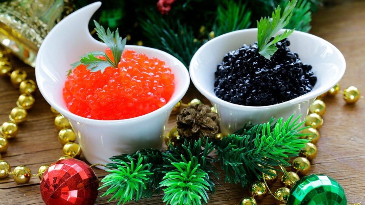 Close-up of gourmet black caviar served in a glass bowl with a mother-of-pearl spoon